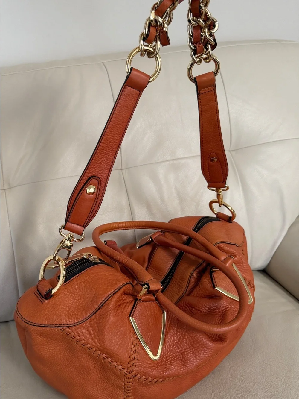 Orange leather handbag appears to be a slouchy style by orYany